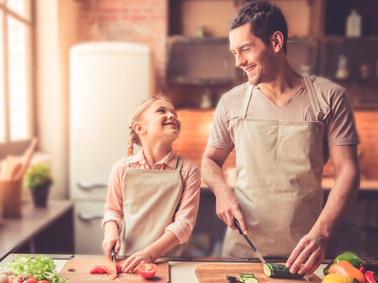 little girl cooking with dad